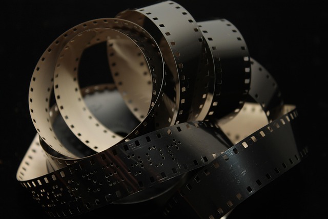 Film reels intertwined with a growing city skyline